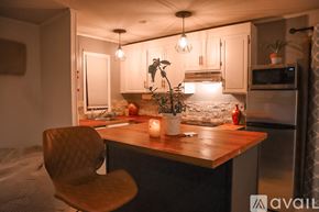 Weston apartment for rent - A room with a bed, a chair, and a table.