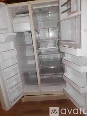 Landers apartment for rent - A white refrigerator with its door open and shelves visible.