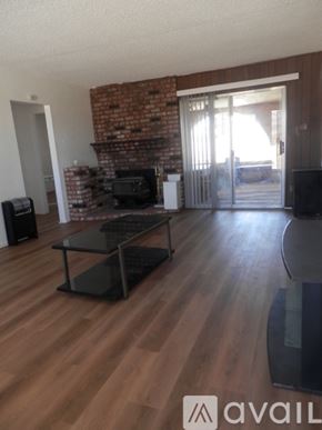 Landers apartment for rent - A living room with a brick wall and wooden floors.
