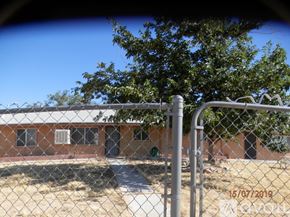 Landers apartment for rent - A chain link fence with a building in the background.