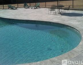 Natchitoches apartment for rent - A pool with a table and chairs around it.
