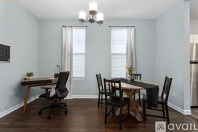 Kansas City apartment for rent - A dining room with a table set for two and a chandelier hanging from the ceiling.