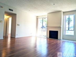 Los Angeles apartment for rent - A spacious room with wooden flooring and a large window.