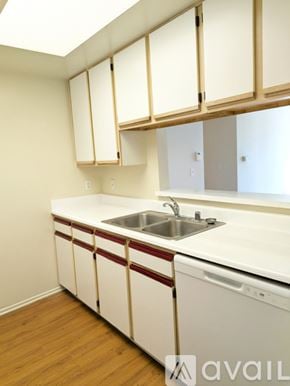 Los Angeles apartment for rent - A room with wooden flooring and white walls.