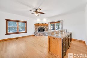 Reno house for rent - A living room with a fireplace and a wooden floor.