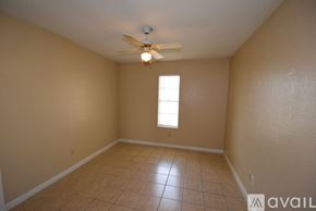Corpus Christi apartment for rent - A room with a ceiling fan and a window.