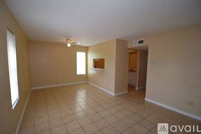 Corpus Christi apartment for rent - A spacious room with tile flooring and a window on the left side.