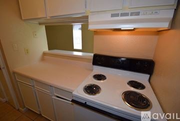 Corpus Christi apartment for rent - A white stove top oven with four burners is in a kitchen.