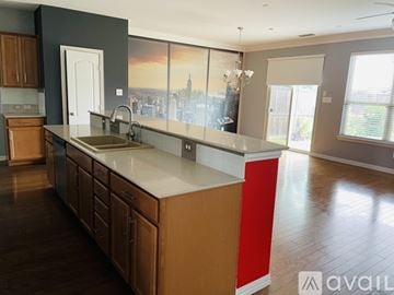 Lewisville house for rent - A kitchen with wooden cabinets and a large island with a sink.
