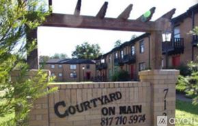 Cleburne apartment for rent - A sign for Courtyard on Main with a phone number on it.