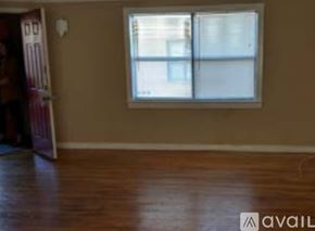 Cleburne apartment for rent - A room with a window and wooden flooring.