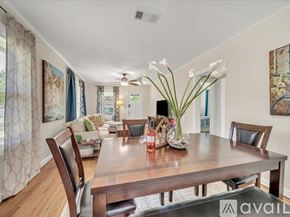 Tulsa house for rent - A dining room with a wooden table and chairs.