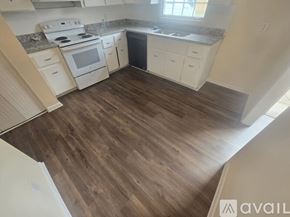 Snellville townhouse for rent - A kitchen with white appliances and wooden floors.
