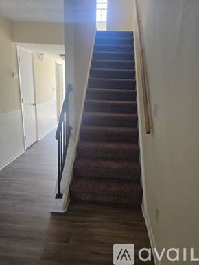 Snellville townhouse for rent - A staircase with a carpeted runner and wooden steps.