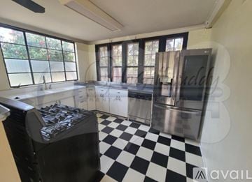 Augusta house for rent - A black and white checkered floor in a kitchen with stainless steel appliances.