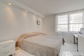 Miami Beach condo for rent - A bedroom with a bed, dresser, and window.
