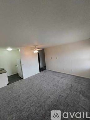 Scotland apartment for rent - A room with a carpeted floor and a door leading to another room.