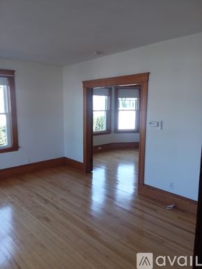 North Andover apartment for rent - A room with wooden floors and a large mirror on the wall.