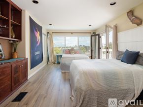 El Segundo townhouse for rent - A bedroom with two beds and a large window overlooking the outdoors.