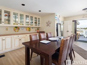 El Segundo townhouse for rent - A dining room with a wooden table and chairs.