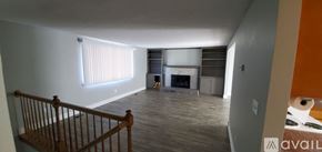 Cheney house for rent - A living room with a fireplace and a balcony.