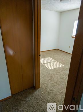 Cheney townhouse for rent - A room with a brown door and a brown wardrobe.