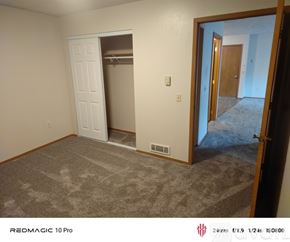 Cheney townhouse for rent - A room with wooden floors and a window with blinds.