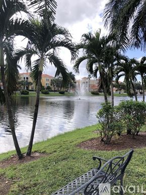 Palm Beach Gardens condo for rent - A park with a fountain, bench and trees.