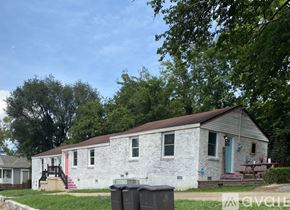 Nashville apartment for rent - A white house with a red door and a brown roof.
