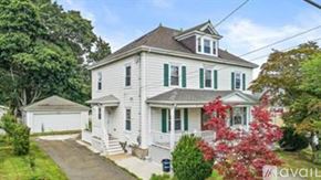 Quincy apartment for rent - A white house with green shutters is for sale.
