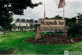 Norwalk apartment for rent - A sign for Norwalk Inn and Adam's Rib Restaurant is in front of a building.