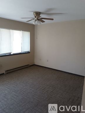 Delphos apartment for rent - A room with a ceiling fan and carpeted floor.
