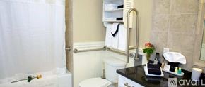 Norwalk apartment for rent - A bathroom with a toilet, sink, and shower curtain.
