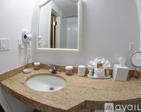 Norwalk apartment for rent - A bathroom sink with a mirror above it and a towel on the counter.