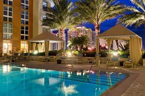West Palm Beach apartment for rent - A pool area with a gazebo and palm trees at night.