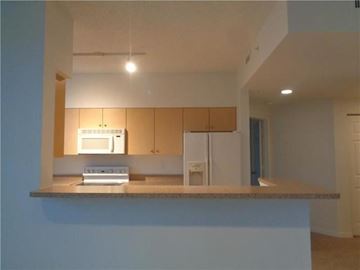 West Palm Beach condo for rent - A kitchen with a microwave and oven built into the cabinetry.