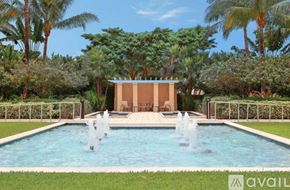 West Palm Beach condo for rent - A pool with a fountain in the middle of it.