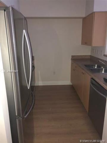 West Palm Beach condo for rent - A kitchen with a refrigerator and a sink.