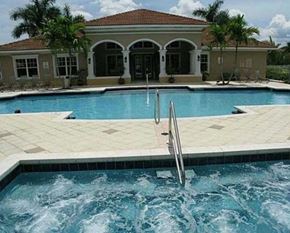 West Palm Beach condo for rent - A pool with a ladder in the middle of it.