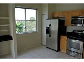 Palm Beach Gardens condo for rent - A kitchen with a refrigerator, microwave, and oven.