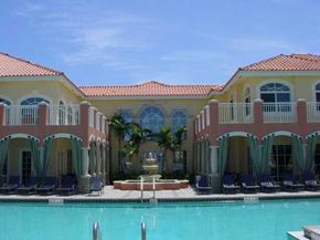 Palm Beach Gardens condo for rent - A large building with a pool in front of it.