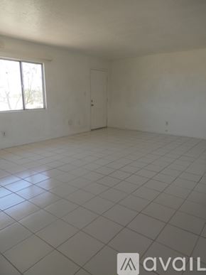Landers house for rent - A large empty room with a tiled floor and a window.