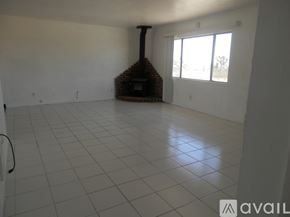 Landers house for rent - A room with a fireplace and tiled flooring.