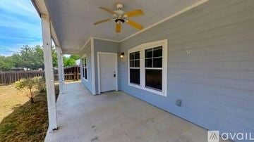San Marcos house for rent - A kitchen with white appliances and wooden cabinets.