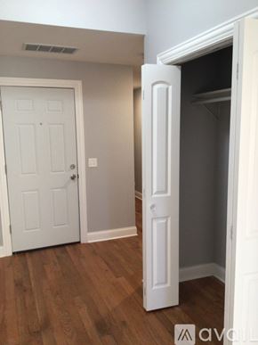Chicago apartment for rent - A white door is open to a dark room.