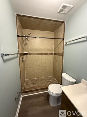 Gastonia apartment for rent - A kitchen with wooden cabinets and a black oven.