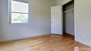 San Marcos house for rent - A room with a white door and a window with a view of trees outside.