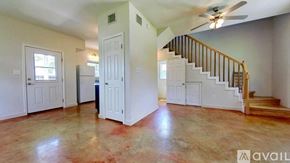 San Marcos house for rent - A spacious room with a staircase and a ceiling fan.