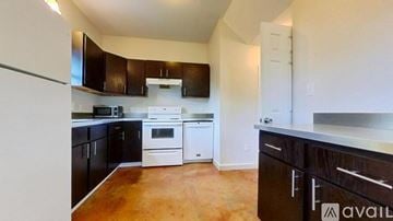 San Marcos house for rent - A kitchen with black cabinets and white appliances.