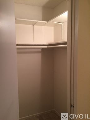 Palmdale apartment for rent - A small, empty room with a white door and a white shelf above it.